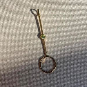 Gold plated with green stone cigarette holder/joint holder ring.